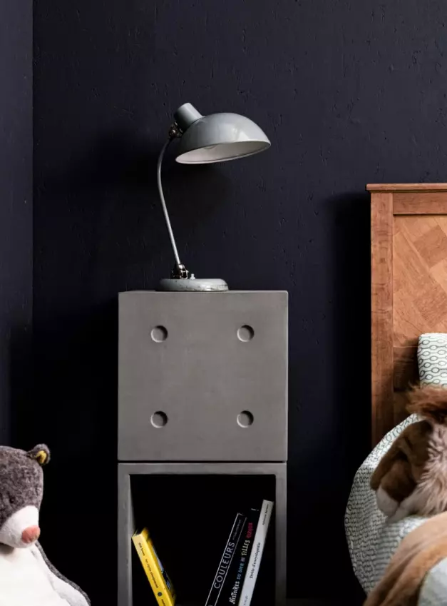 Two stacked Dice concrete cubes are perfect for a trendy bedside table with storage here with a vintage lamp