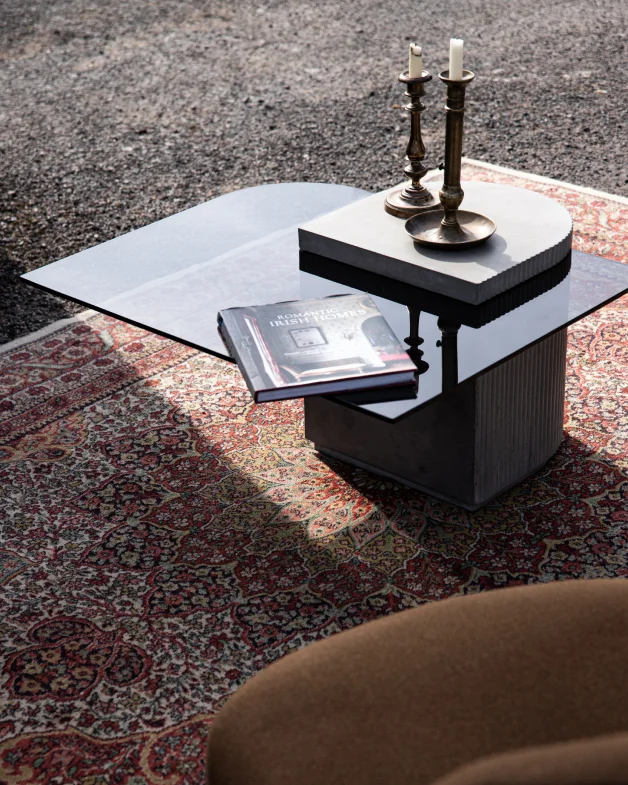 Vintage candle holder on the concrete and glass coffee table from the Strut's collection from Lyon Beton