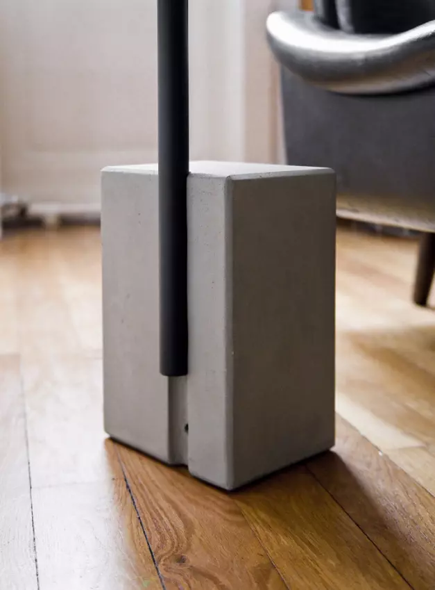 The concrete ballast of the Twist pedestal table holds the mat of the swivel top of this side table