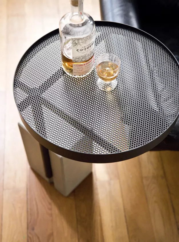 The swivel top of this concrete side table is perfect for keeping your glass safe during drinks