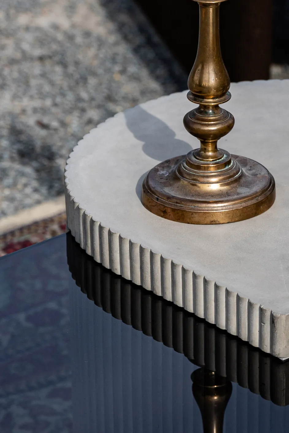 Vintage candle holder on the concrete and glass coffee table from the Strut de Lyon Concrete collection