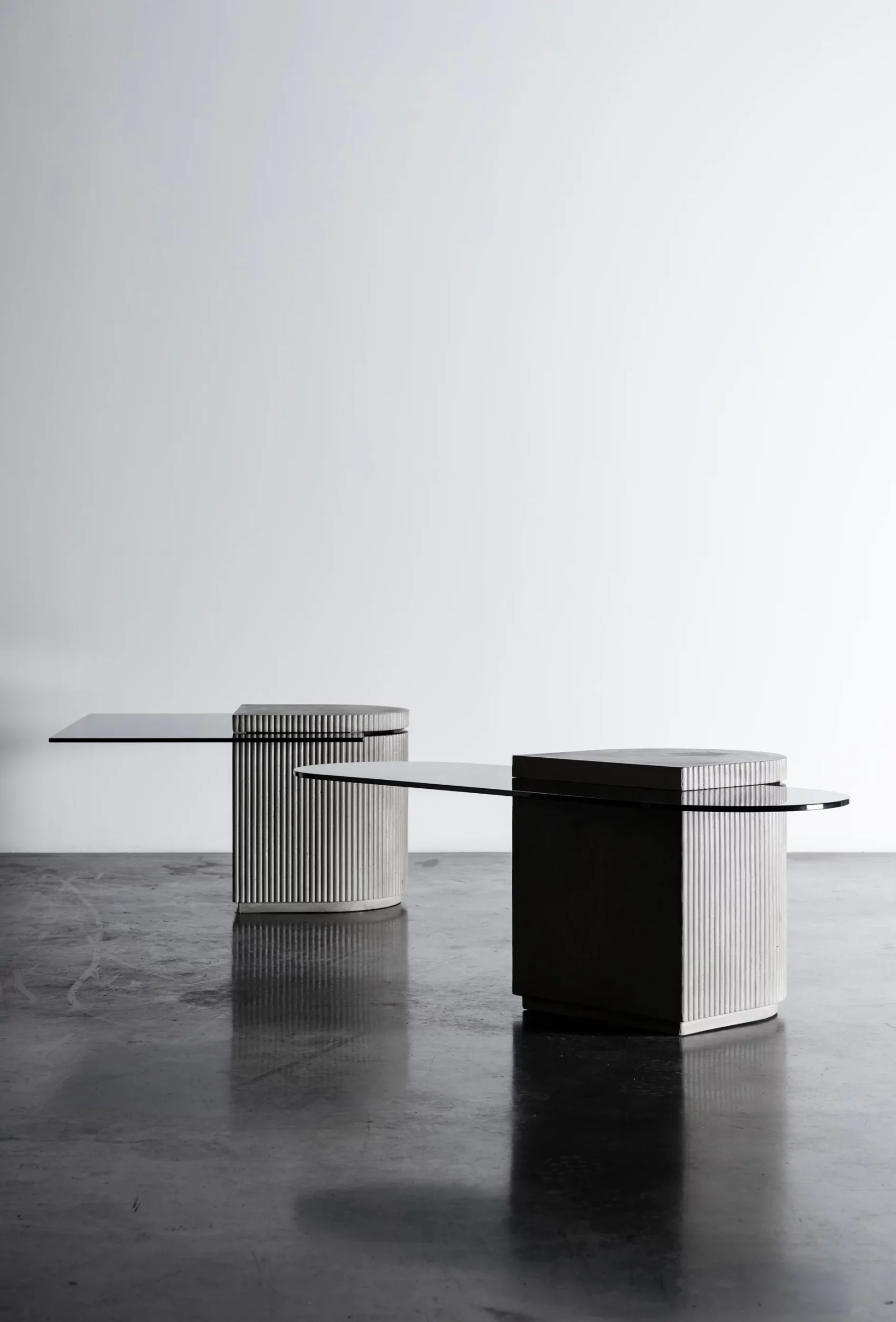 Concrete and hybrid glass cabinet between a coffee table and an extra table