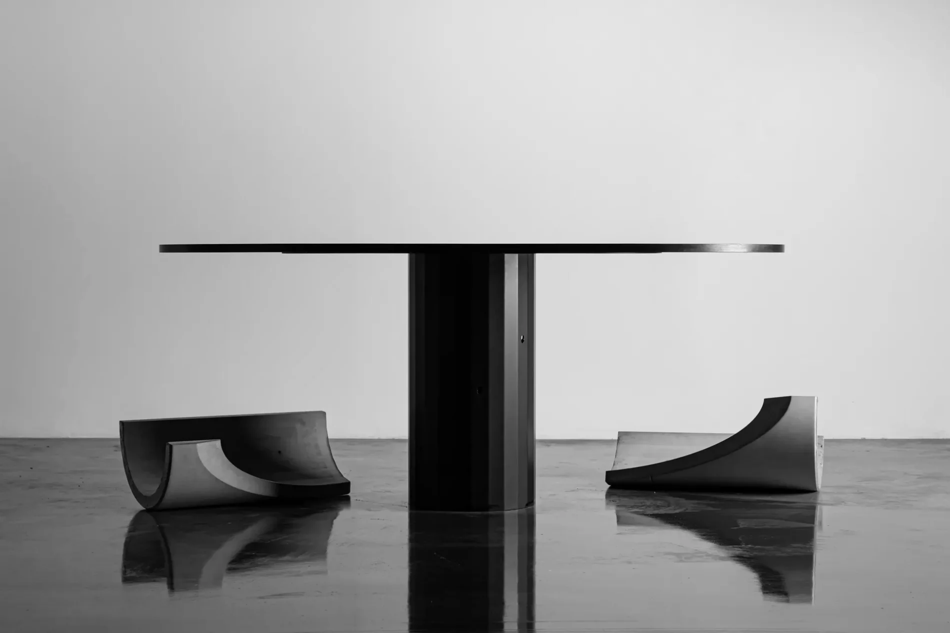 The Sharp dining table reveals itself by dropping its reversible concrete shell
